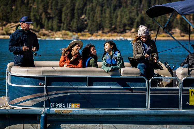 Young people on a boat fishing