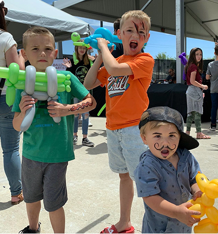 Little boys with painted faces having fun.